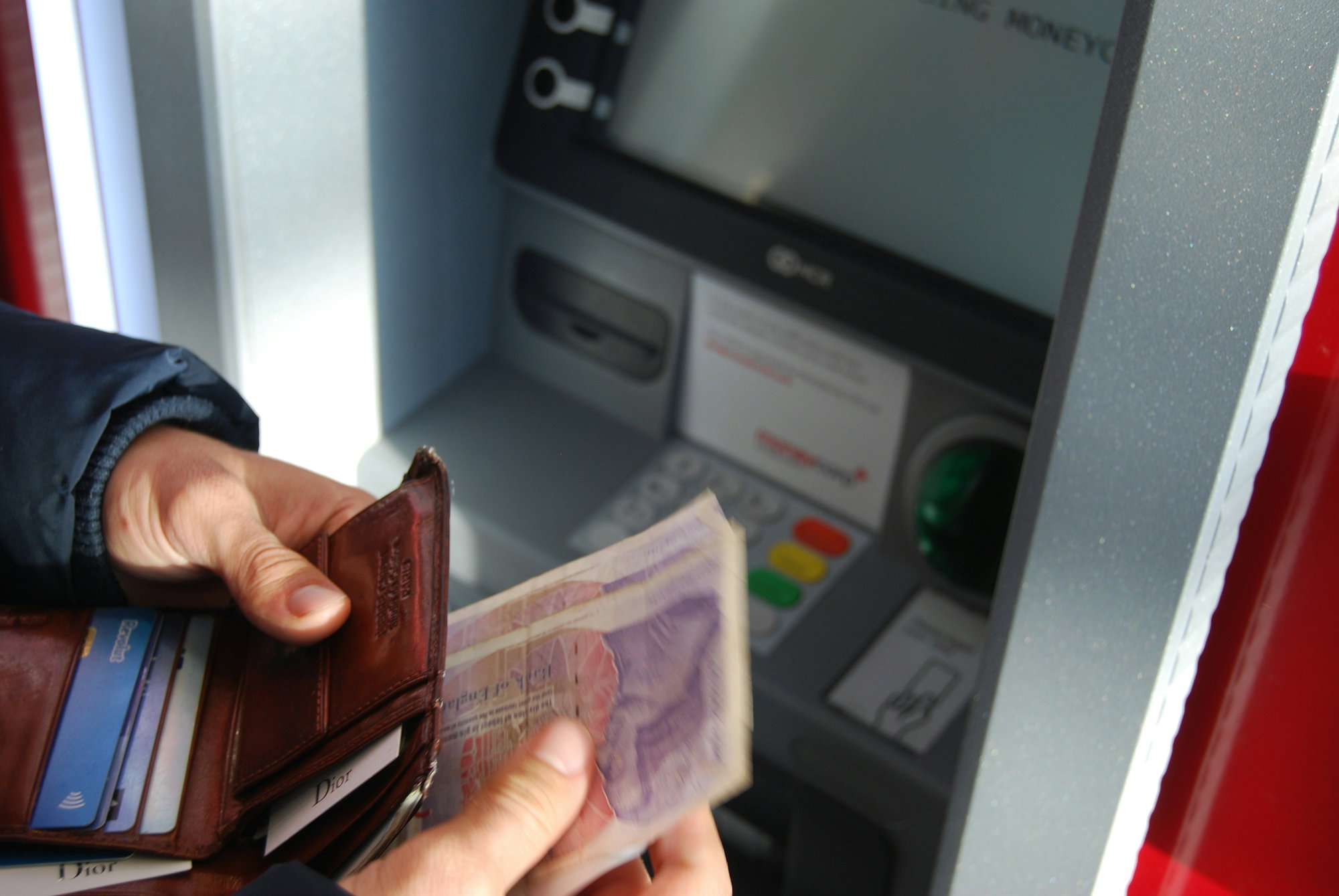 person-holding-brown-leather-wallet-and-banknotes.jpg person holding brown leather wallet and banknotes